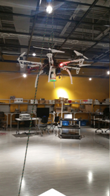 Figure 2: UAV hung from ceiling grid for wireless channel measurement using Alford Loop Reconfigurable Antenna